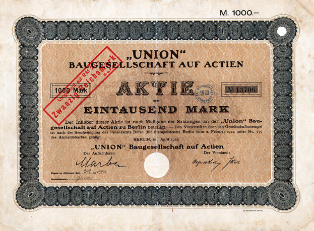 Eine alte deutsche Banknote mit einem roten Stempel und Text, der darauf hinweist, dass es ein Aktienzertifikat ist.