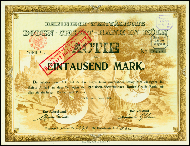 Ein gerahmtes deutsches Bankzertifikat mit einem ernsten Mann im Anzug und Krawatte, Text und einem Stempel.