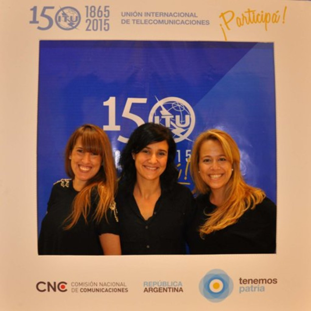 Ein Foto rahmen mit drei Frauen auf einem blauen Hintergrund, umgeben von den Namen verschiedener Sponsoren und einem Unternehmensnamen.