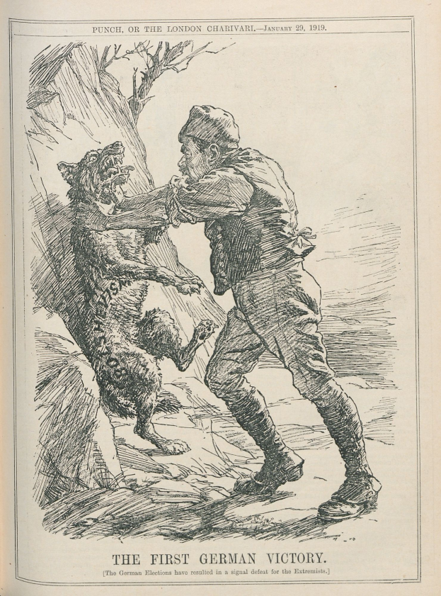 Ein aufgeschlagenes Buch mit einer Zeichnung eines Mannes mit Hut und einem Hund neben ihm, mit der Aufschrift "Der erste deutsche Sieg" auf der Seite.