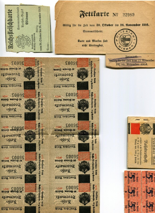 Sammlung alter deutscher Fahrkarten und Marken auf einem weißen Hintergrund, einige mit gedrucktem Text und Zahlen.